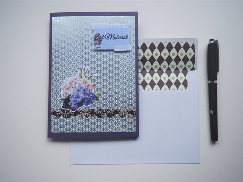 Silver Eid Mubarak handmade card on purple with floral detail and matching lined envelope