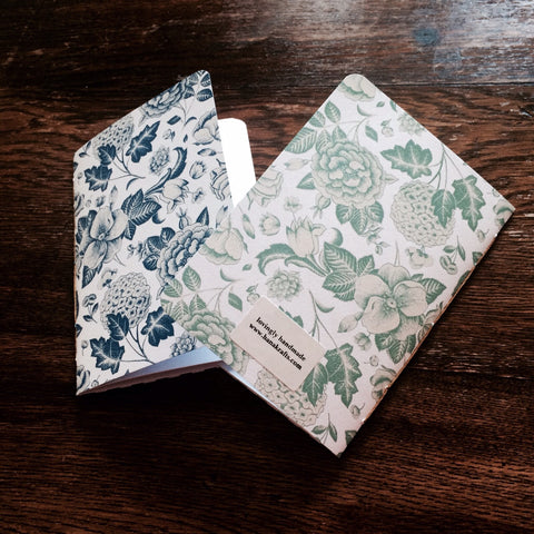 Blue and green hand-bound botanical journals
