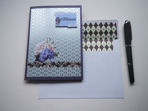 Silver Eid Mubarak handmade card on purple with floral detail and matching lined envelope