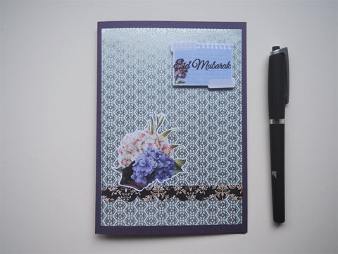 Silver Eid Mubarak handmade card on purple with floral detail and matching lined envelope