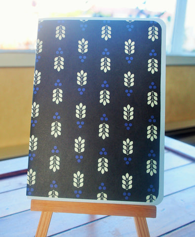 Minimalist leaf design on black paper card and envelope set
