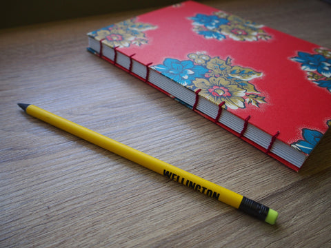 Children's hand-bound travel journal with exclusively designed activity pages in colour and a visible coptic stitch