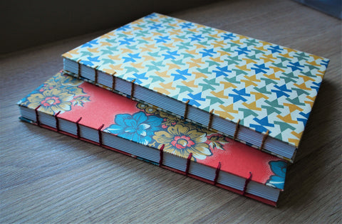 Children's hand-bound travel journal with exclusively designed activity pages in colour and a visible coptic stitch