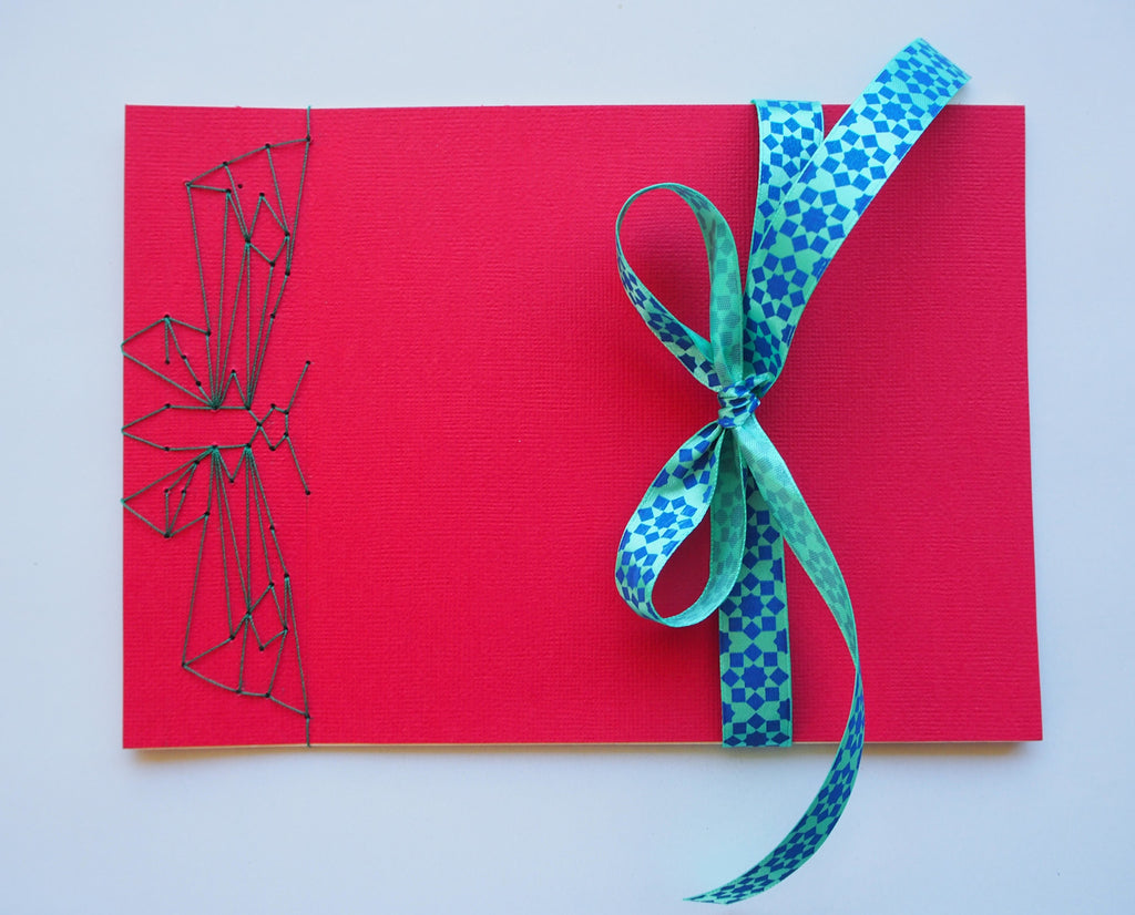 Festive special: notebooks with unique hand-bound decorative designs in red with butterfly binding