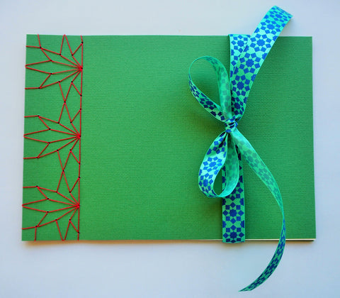 Festive special: notebooks with unique hand-bound decorative designs in forest green with maple leaves binding