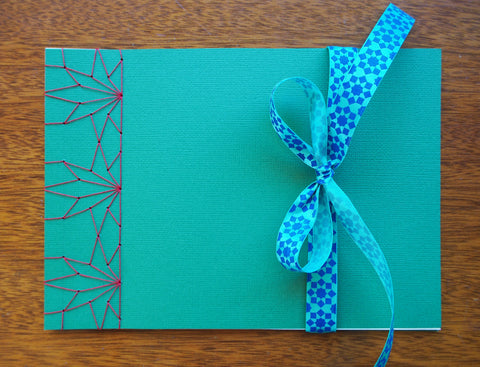 Festive special: notebooks with unique hand-bound decorative designs in forest green with maple leaves binding