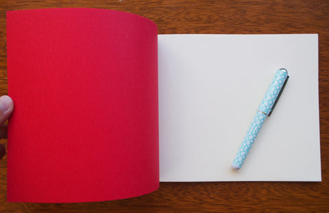 Festive special: notebooks with unique hand-bound decorative designs in red with butterfly binding
