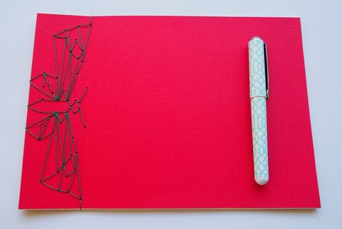 Festive special: notebooks with unique hand-bound decorative designs in red with butterfly binding