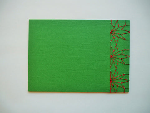 Festive special: notebooks with unique hand-bound decorative designs in forest green with maple leaves binding