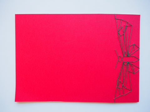 Festive special: notebooks with unique hand-bound decorative designs in red with butterfly binding