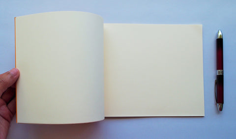 Festive special: notebooks with unique hand-bound decorative designs in rich yellow with kissing fish binding